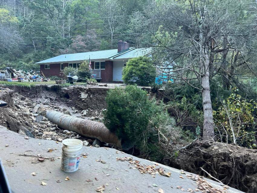 Hurricane Damage Home Home on top of dirt cliff after Hurricane Helene