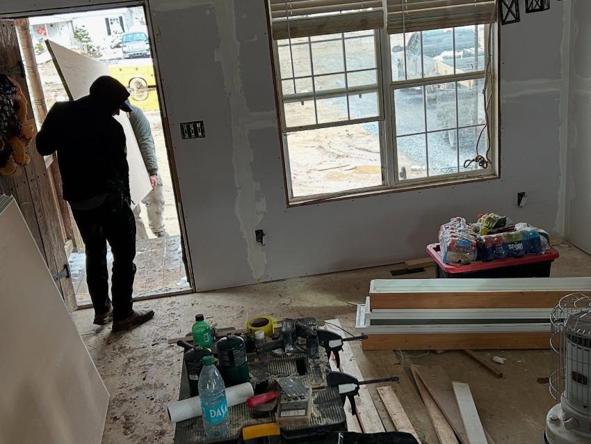 Mountain Mule Packers volunteers Man inside a home being repaired