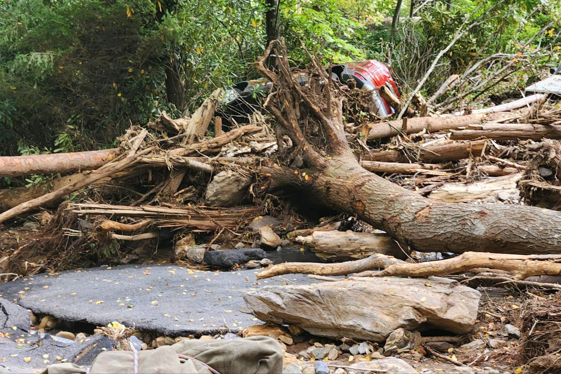 ruined road in western north carolina with a car upside down