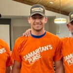 3 men wearing ball caps with words Mission Mules and orange tee shirts with words Samaritan's Purse